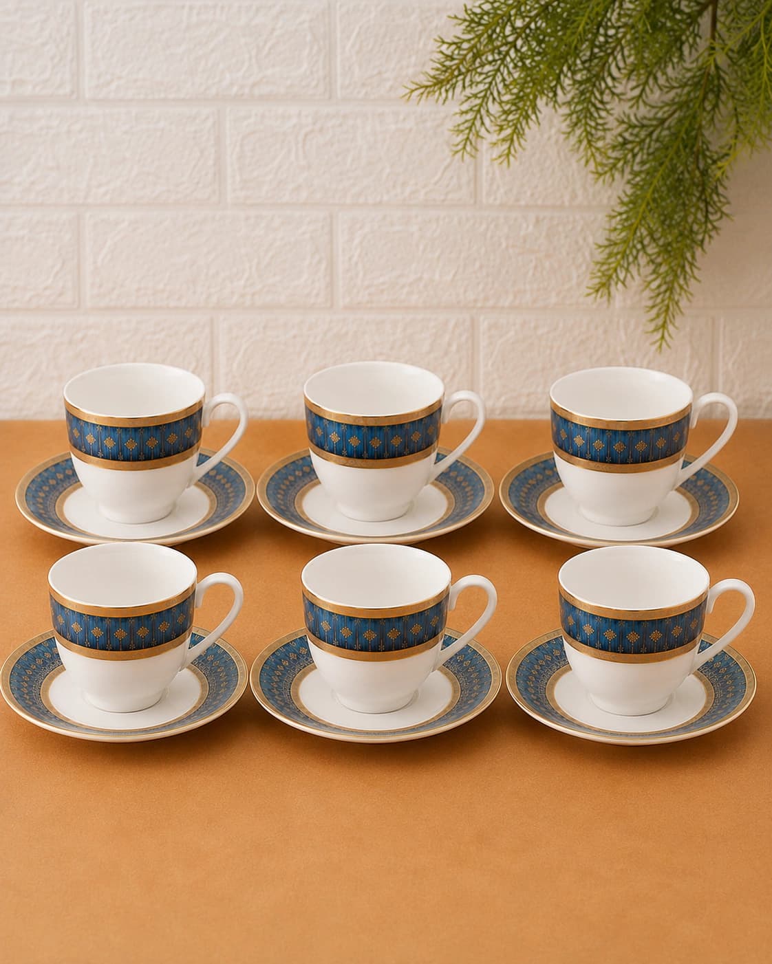 Blue and gold ceramic cup and saucer set arranged in two rows